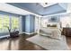 Bright main bedroom offers a tray ceiling, large windows, and exercise equipment at 4729 Woodland Brook Se Ct, Atlanta, GA 30339
