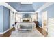 Spacious main bedroom with blue walls, tray ceiling, and ensuite bathroom entrance at 4729 Woodland Brook Se Ct, Atlanta, GA 30339