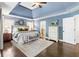 This bedroom boasts a tray ceiling, hardwood floors, and convenient access to the bathroom at 4729 Woodland Brook Se Ct, Atlanta, GA 30339