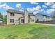 Spacious fenced backyard and the exterior facade of the house at 148 Crystal Downs Way, Suwanee, GA 30024