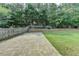 Fenced backyard featuring a stone patio and green grass at 148 Crystal Downs Way, Suwanee, GA 30024