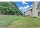 Large, fenced backyard with mature trees providing shade and privacy at 148 Crystal Downs Way, Suwanee, GA 30024