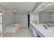 Bathroom featuring double sinks, bathtub and large mirror at 148 Crystal Downs Way, Suwanee, GA 30024