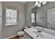Bathroom featuring a large mirror, vanity, toilet, and natural light from a window at 148 Crystal Downs Way, Suwanee, GA 30024