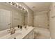 Bathroom featuring double sinks, large mirror, vanity lighting, and a shower/tub combo at 148 Crystal Downs Way, Suwanee, GA 30024