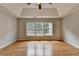 Bright bedroom featuring hardwood floors, tray ceiling, and large windows at 148 Crystal Downs Way, Suwanee, GA 30024