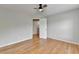 Bedroom with hardwood floors, ceiling fan, and access to the upper floor at 148 Crystal Downs Way, Suwanee, GA 30024