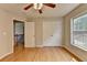 Inviting bedroom with hardwood floors, closet, and a window overlooking the backyard at 148 Crystal Downs Way, Suwanee, GA 30024