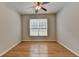 Bedroom with hardwood floors and a large window offering plenty of natural light at 148 Crystal Downs Way, Suwanee, GA 30024