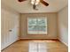 Cozy bedroom featuring hardwood floors, a ceiling fan, and a window for natural light at 148 Crystal Downs Way, Suwanee, GA 30024