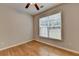 Bedroom with hardwood floors and a window overlooking the backyard at 148 Crystal Downs Way, Suwanee, GA 30024