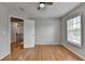 This bedroom has hardwood floors, neutral paint, and a window to bring in natural light at 148 Crystal Downs Way, Suwanee, GA 30024