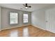 This bedroom features hardwood floors, neutral paint, and two windows for natural light at 148 Crystal Downs Way, Suwanee, GA 30024