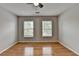 An inviting bedroom is well-lit by two windows and features a ceiling fan at 148 Crystal Downs Way, Suwanee, GA 30024