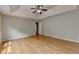 Bedroom boasts tray ceiling, hardwood floors and a ceiling fan at 148 Crystal Downs Way, Suwanee, GA 30024