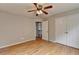 Comfortable bedroom showcasing hardwood floors, closet, and ceiling fan at 148 Crystal Downs Way, Suwanee, GA 30024