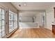 A cozy breakfast nook has light-filled windows and hardwood floors at 148 Crystal Downs Way, Suwanee, GA 30024