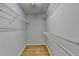 Walk-in closet with shelving and laminate wood flooring at 148 Crystal Downs Way, Suwanee, GA 30024
