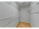 Walk-in closet with shelving and laminate wood flooring at 148 Crystal Downs Way, Suwanee, GA 30024