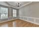 Elegant dining room featuring hardwood floors, chandelier, and large windows at 148 Crystal Downs Way, Suwanee, GA 30024