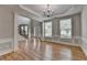 Open-concept dining room with hardwood floors, natural light, and adjacent staircase at 148 Crystal Downs Way, Suwanee, GA 30024