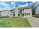 Rear exterior of the two-story home showcasing siding, windows, and a spacious yard at 148 Crystal Downs Way, Suwanee, GA 30024