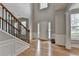 Grand foyer with hardwood floors, a staircase, and high ceilings at 148 Crystal Downs Way, Suwanee, GA 30024