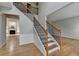 Open foyer featuring hardwood floors, staircase, and view into living room at 148 Crystal Downs Way, Suwanee, GA 30024