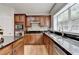 Modern kitchen boasts cherry cabinets, granite countertops, stainless appliances, and mosaic backsplash at 148 Crystal Downs Way, Suwanee, GA 30024