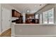 Elegant kitchen boasts cherry cabinets, granite countertops, and stainless steel appliances, perfect for cooking at 148 Crystal Downs Way, Suwanee, GA 30024