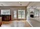 Open kitchen features stainless steel appliances, granite countertops, and bright backyard views at 148 Crystal Downs Way, Suwanee, GA 30024