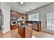 Updated kitchen with cherry cabinets, granite countertops, stainless appliances, and kitchen island at 148 Crystal Downs Way, Suwanee, GA 30024