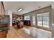 Well-lit kitchen features cherry cabinetry, granite countertops, stainless appliances, and backyard view at 148 Crystal Downs Way, Suwanee, GA 30024