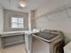 Laundry room featuring new washer/dryer, shelf, window, and neutral paint at 148 Crystal Downs Way, Suwanee, GA 30024