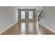 Bright living room boasts hardwood flooring and natural light from two large windows at 148 Crystal Downs Way, Suwanee, GA 30024
