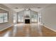 Spacious living room with hardwood floors, fireplace, and large windows at 148 Crystal Downs Way, Suwanee, GA 30024