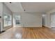 Living room featuring hardwood floors, fireplace, and large windows for natural light at 148 Crystal Downs Way, Suwanee, GA 30024