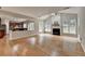 Open-concept living room with hardwood floors, fireplace, and view into the kitchen at 148 Crystal Downs Way, Suwanee, GA 30024
