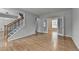 Spacious living room featuring hardwood floors, staircase, and bright, natural light at 148 Crystal Downs Way, Suwanee, GA 30024