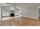 Living room with hardwood floors, fireplace, and plenty of natural light at 148 Crystal Downs Way, Suwanee, GA 30024