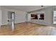 Open concept living room showcasing hardwood floors and a seamless transition into the modern kitchen at 148 Crystal Downs Way, Suwanee, GA 30024