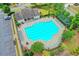 Aerial view of a community pool with lounge seating and landscaping; ideal for recreation and relaxation at 148 Crystal Downs Way, Suwanee, GA 30024