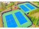 Aerial view of well-maintained community tennis courts, providing ample space for recreational play at 148 Crystal Downs Way, Suwanee, GA 30024