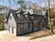 An exquisite home has stone details and large windows that complement the architecture at 270 Boulder Dr, Roswell, GA 30075