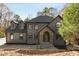 An immaculate home has stone detailing around a grand arched front entry at 270 Boulder Dr, Roswell, GA 30075