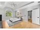 A bright main bedroom with a large window, light-colored walls, and light hardwood floors at 270 Boulder Dr, Roswell, GA 30075