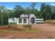 Contemporary home featuring a unique design with black and white accents nestled amongst lush greenery at 5210 Brownlee Rd, Stone Mountain, GA 30087