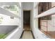 Hallway with white interior and window views of exterior surroundings and door to construction area at 5210 Brownlee Rd, Stone Mountain, GA 30087
