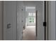 Hallway with white interior doors and trim, and a view to a living area with many windows at 5210 Brownlee Rd, Stone Mountain, GA 30087
