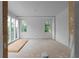 Bright living room featuring light wall color and many windows overlooking trees at 5210 Brownlee Rd, Stone Mountain, GA 30087